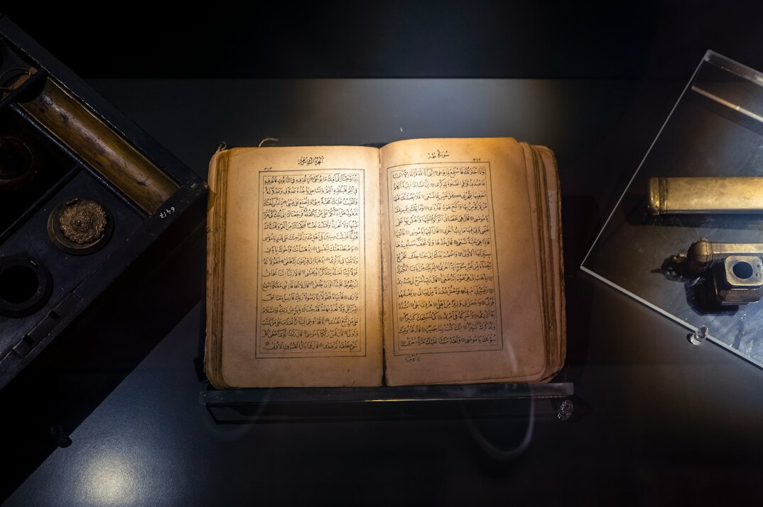 Open old book with a magnifying glass on top