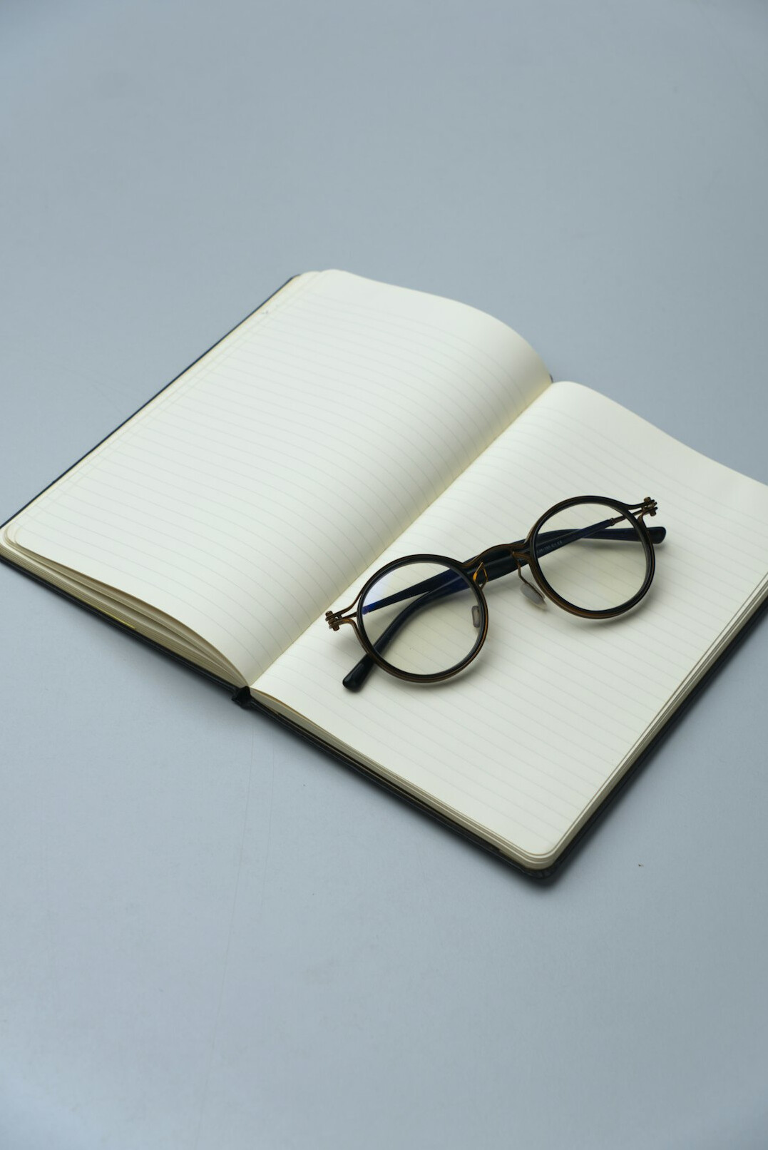 Detective notebook with magnifying glass on a wooden desk